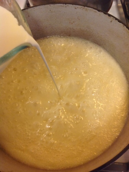 pouring heavy cream into caramel