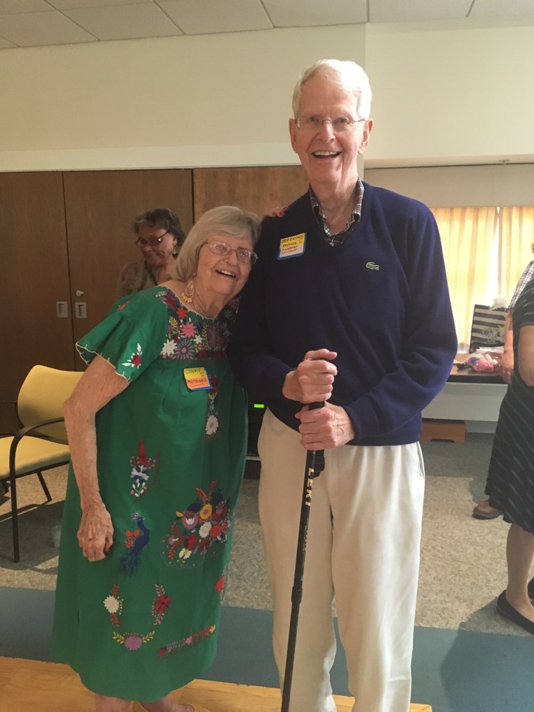 Image of two elderly siblings at a birthday party.